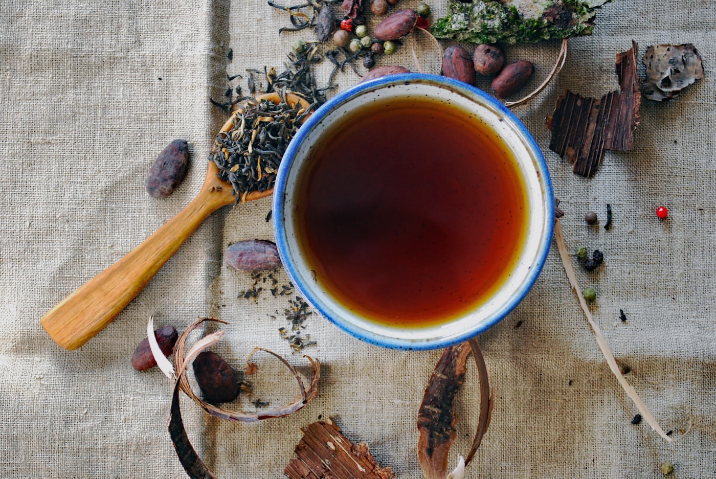 Warm cup of tea on a wooden table by a window at dusk